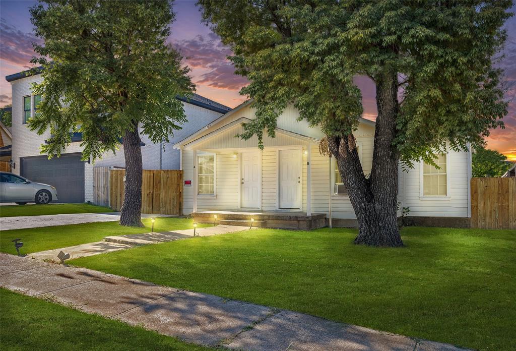 a big house with a big yard and large trees