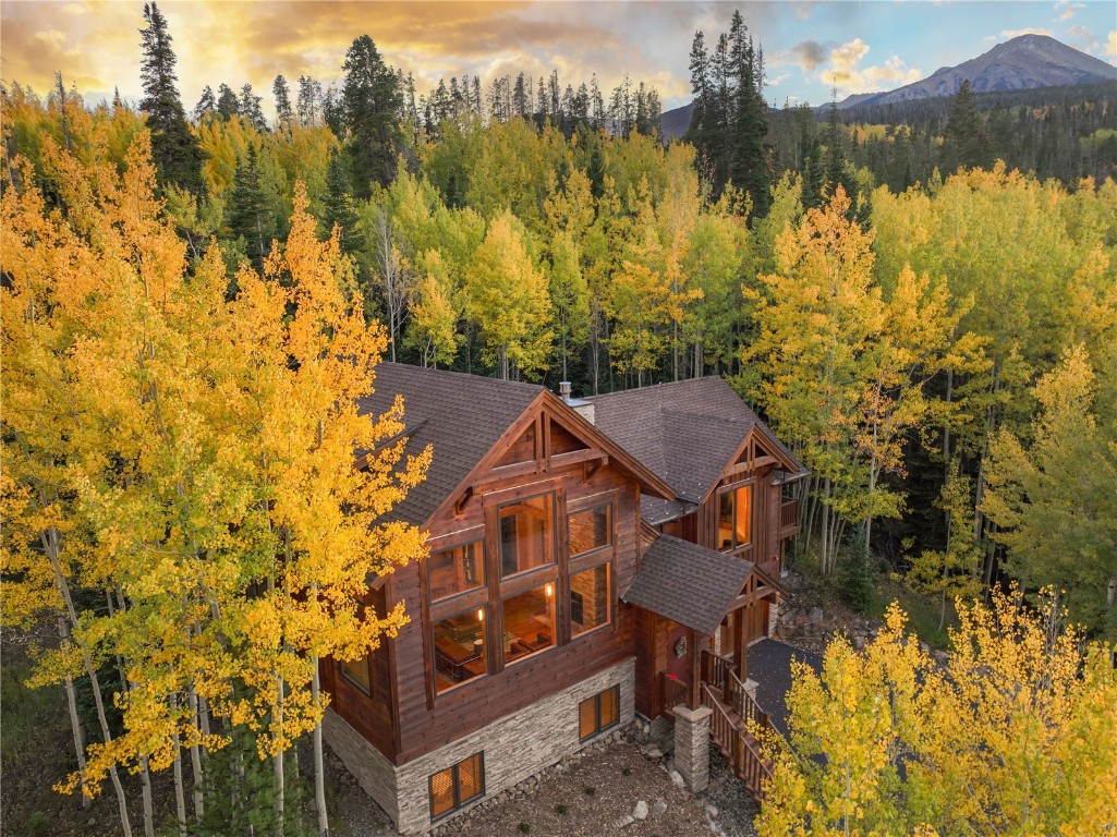 a view of a house with a yard next to a lake