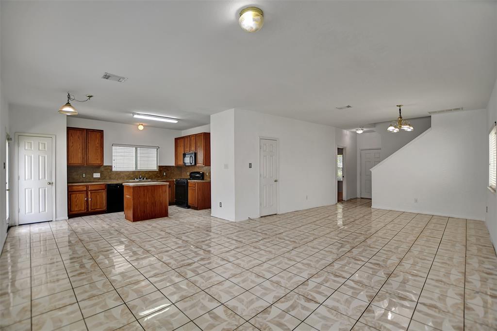 a view of kitchen with stainless steel appliances granite countertop a refrigerator and a sink