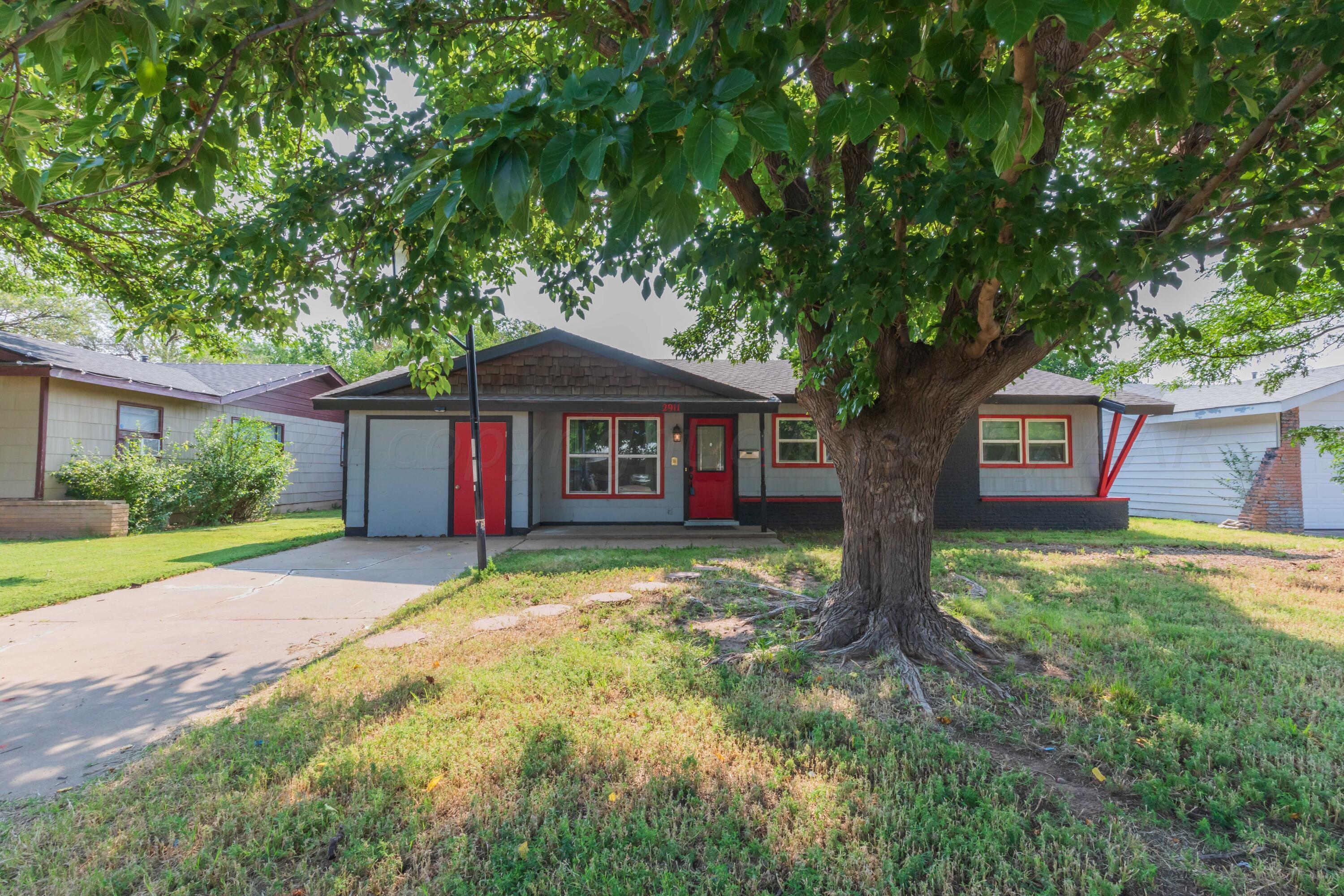 a large tree in front of a house