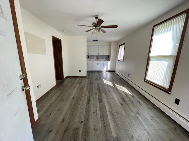 a view of empty room with wooden floor and window