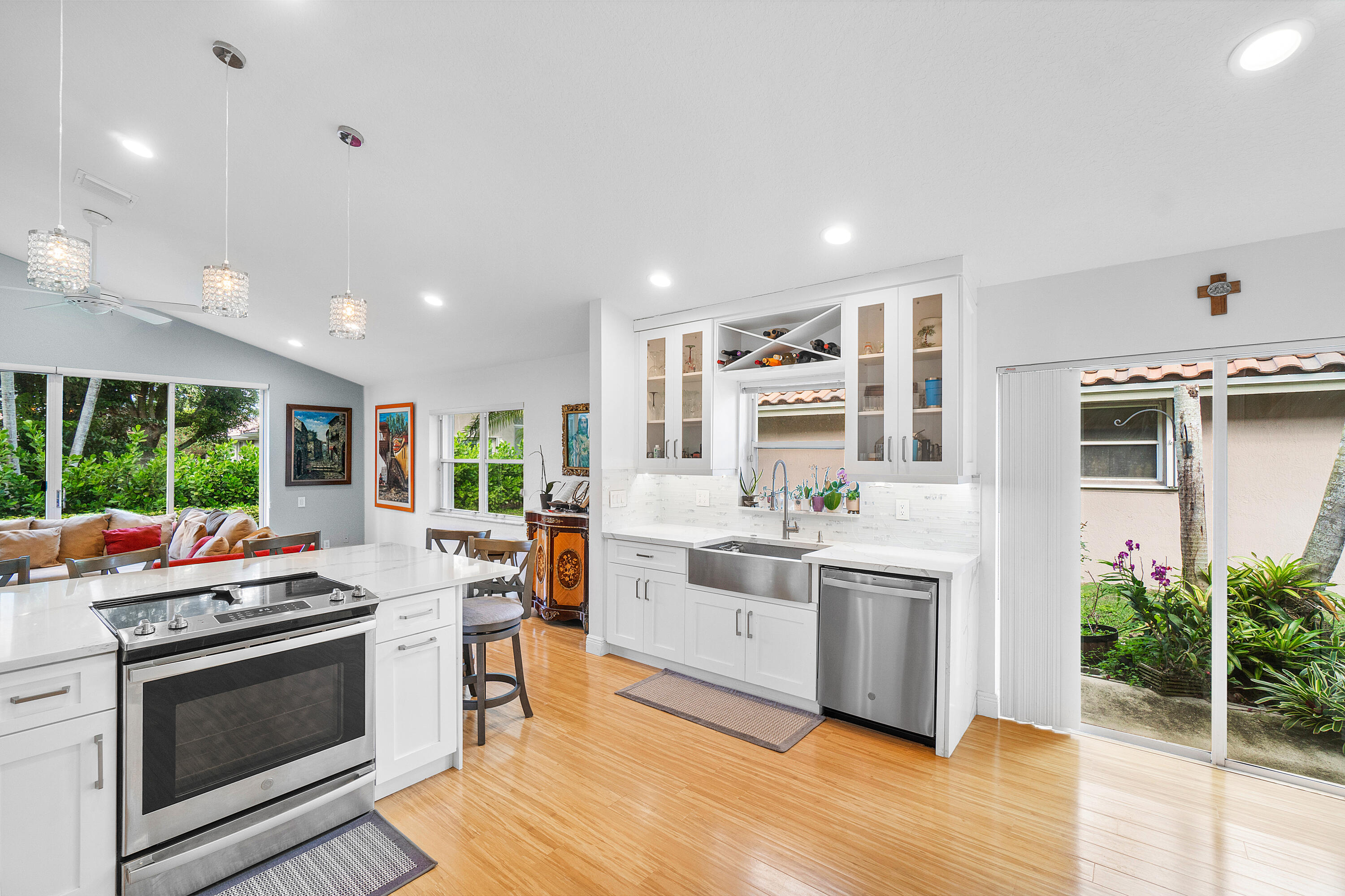 a kitchen that has a lot of cabinets in it and stainless steel appliances