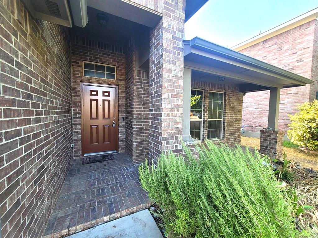 a view of house with backyard and glass windows