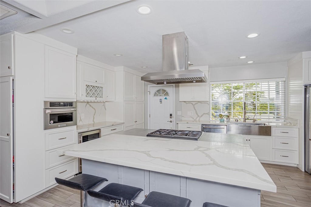 a kitchen with a stove a refrigerator and cabinets