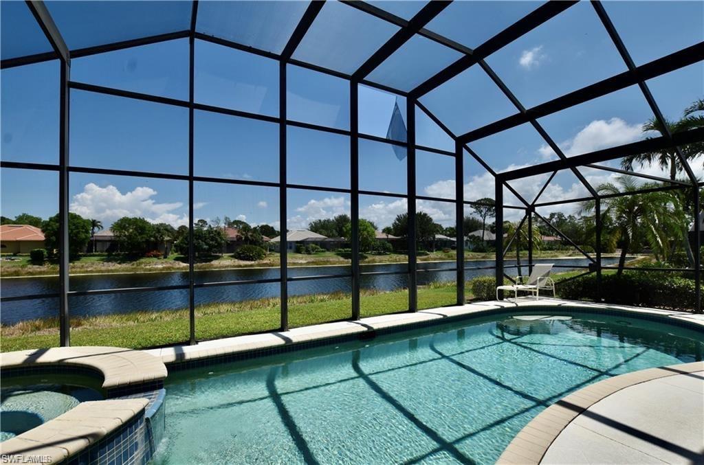 a view of a swimming pool with a bench in front of it