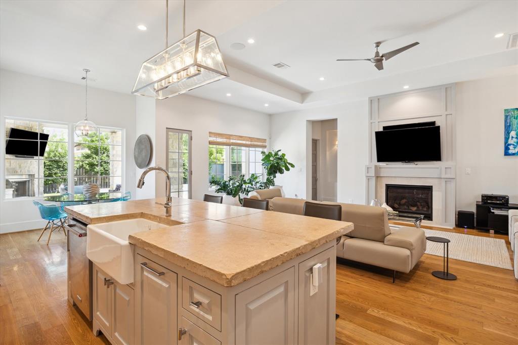 a large kitchen with sink a microwave and living room view