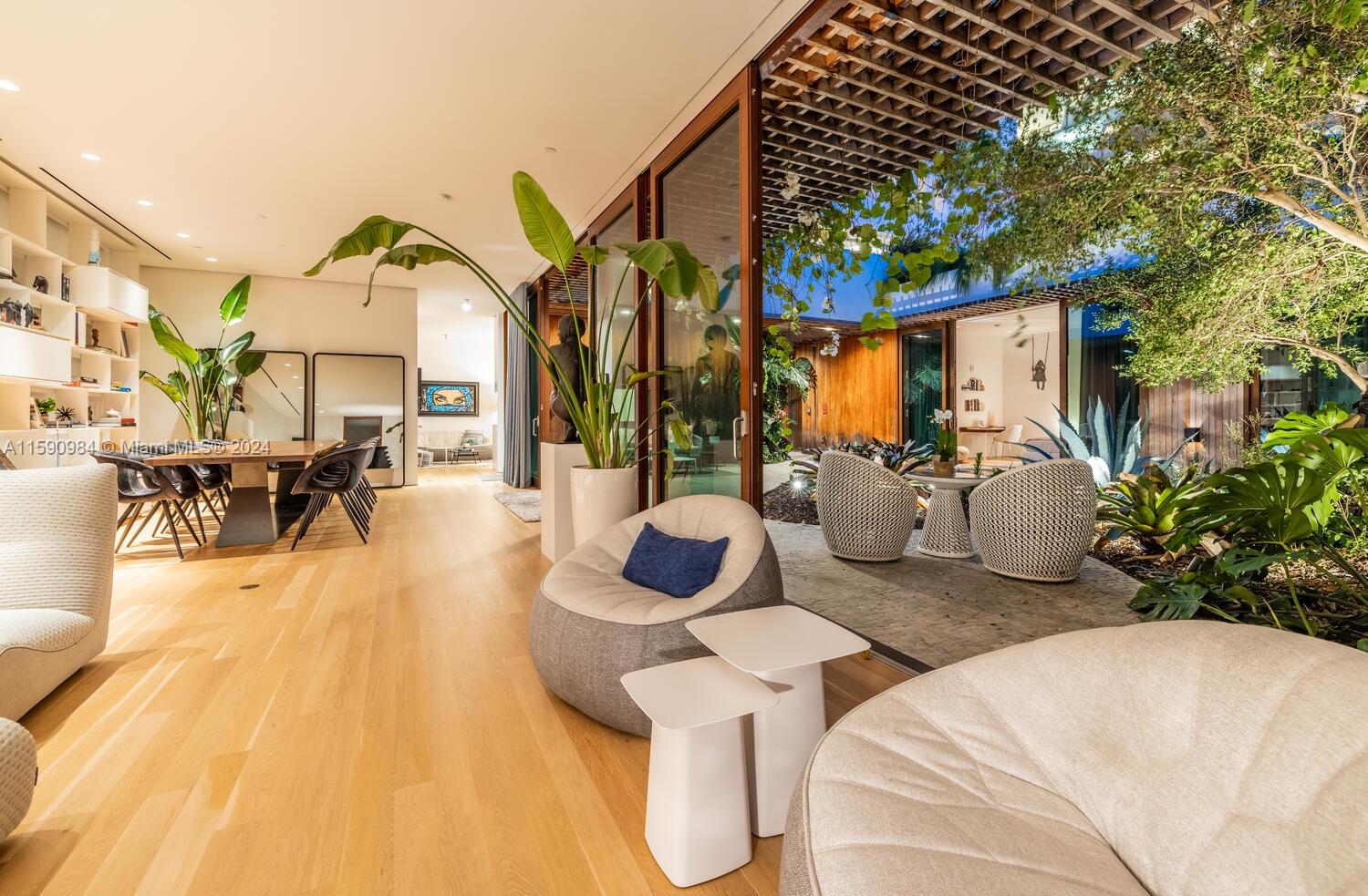 a view of a patio with couches table and chairs and potted plants