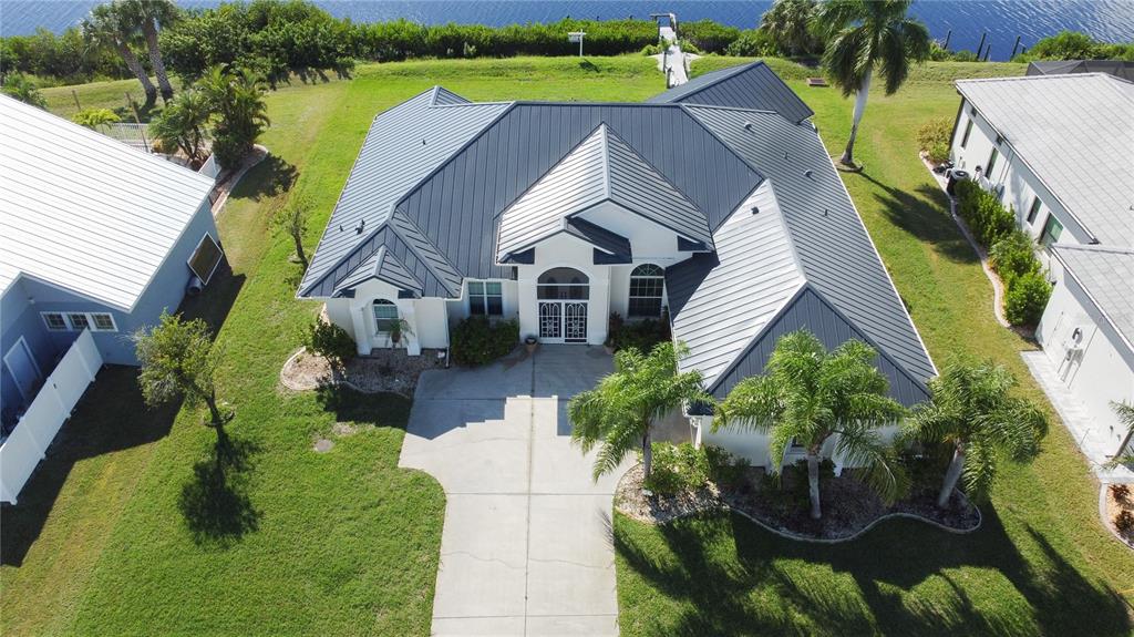 a aerial view of a house with swimming pool and a garden