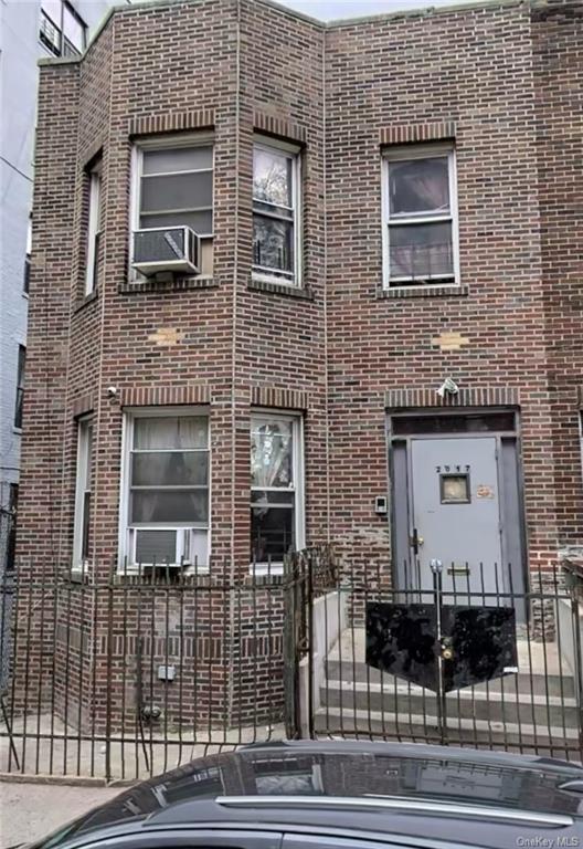 a view of a brick house with many windows