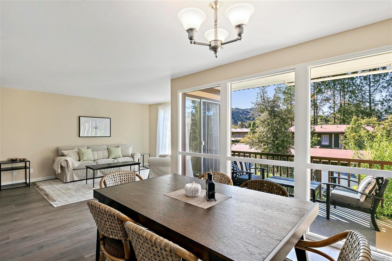 a view of a dining room with furniture large windows and wooden floor