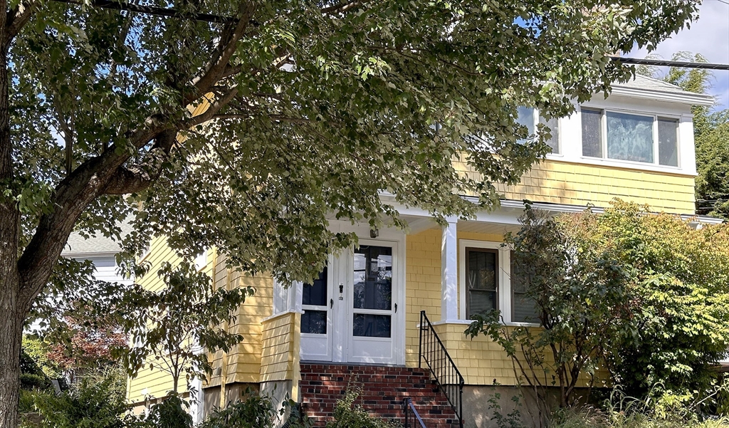 a view of a house with a tree