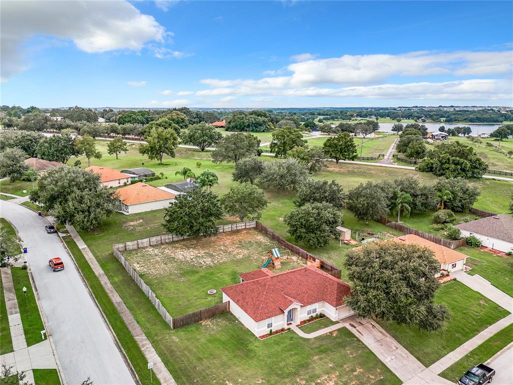 an aerial view of residential houses with outdoor space and street view