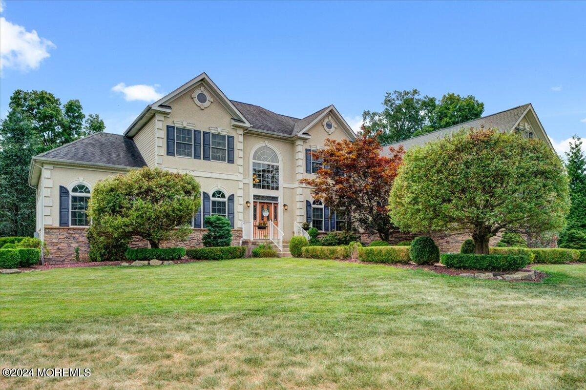 a front view of a house with a yard