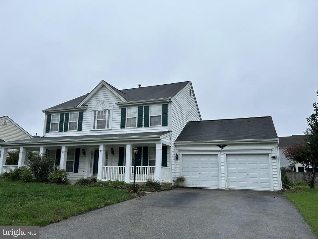 a front view of a house with a garden and garage