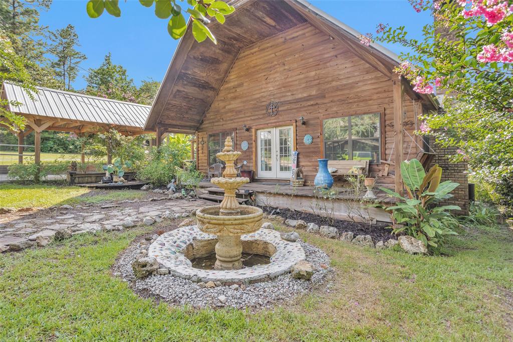 a view of a house with backyard porch and sitting area