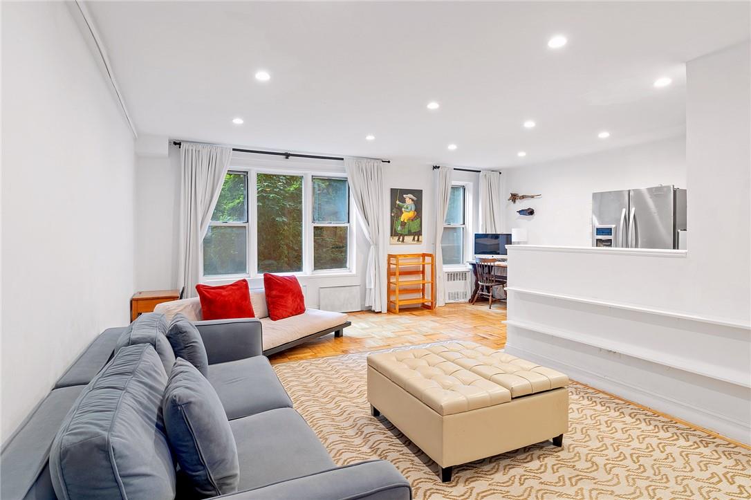 a living room with furniture and a large window