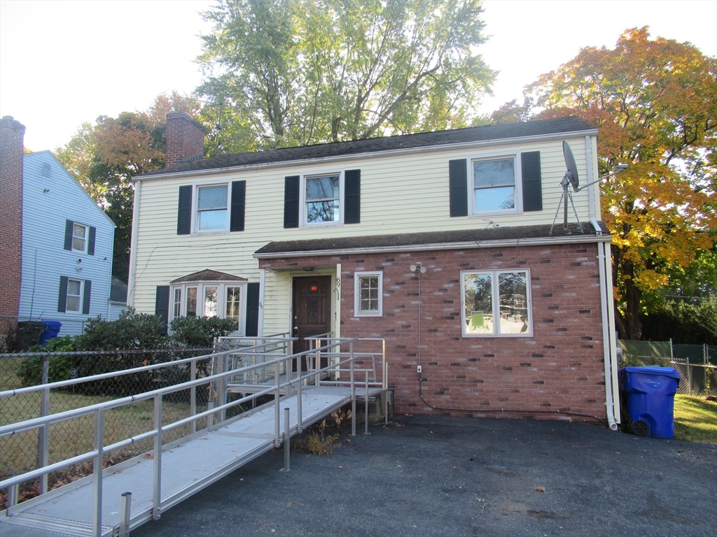 a view of a house with a yard and sitting space