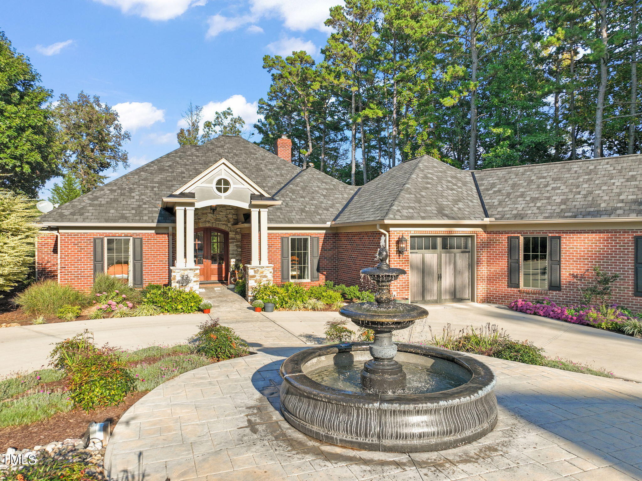 a front view of a house with a yard fire pit and outdoor seating