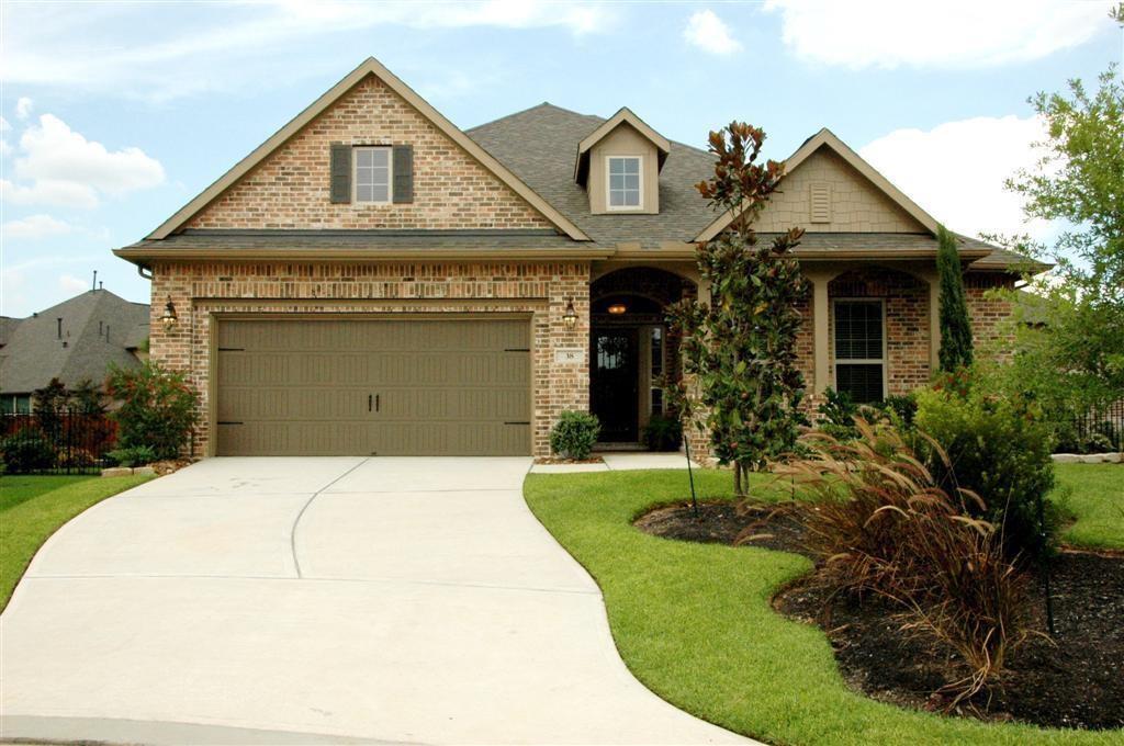 a front view of a house with a garden and plants