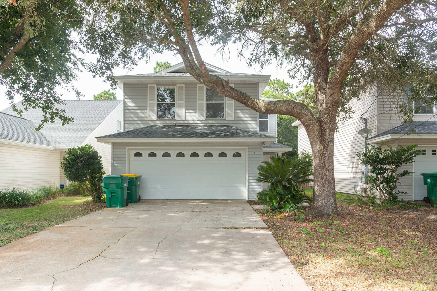 a front view of house with yard and trees around