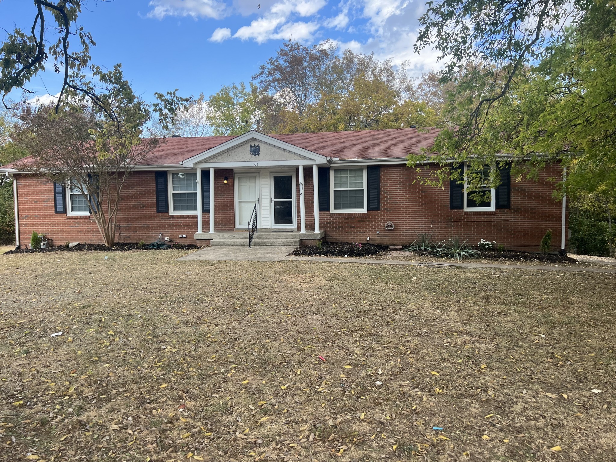 a front view of a house with a yard