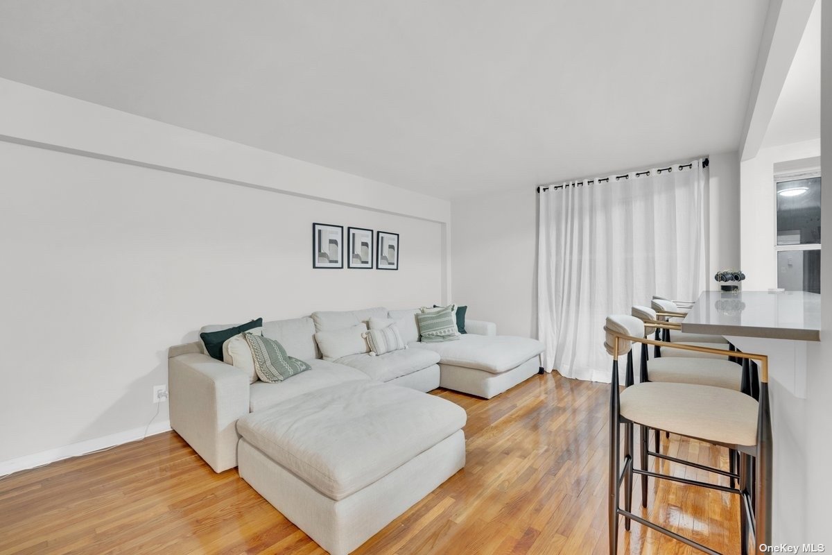 a living room with furniture and large windows