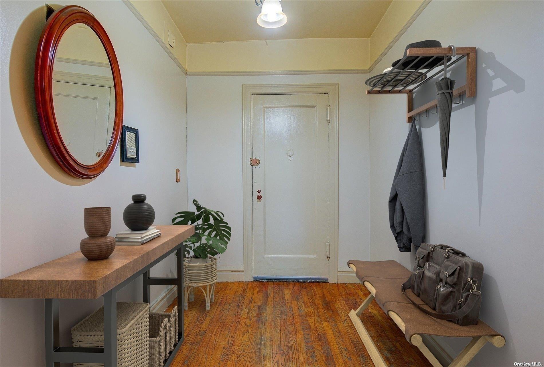 a view of a entryway with furniture and wooden floor