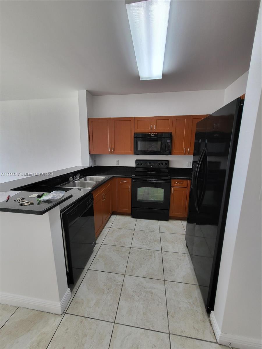 a kitchen with a stove top oven and cabinets