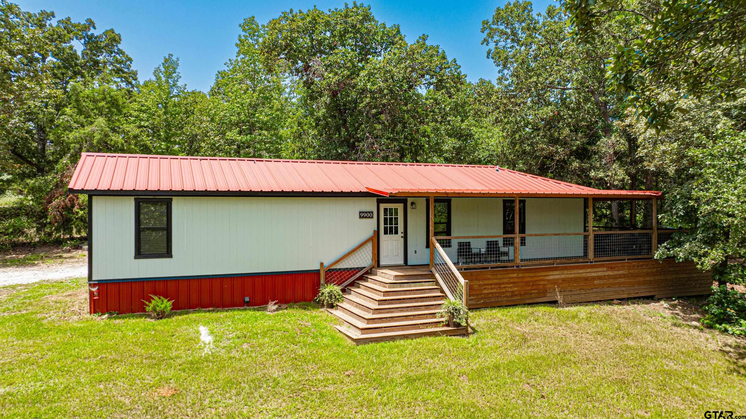 a front view of a house with swimming pool and porch