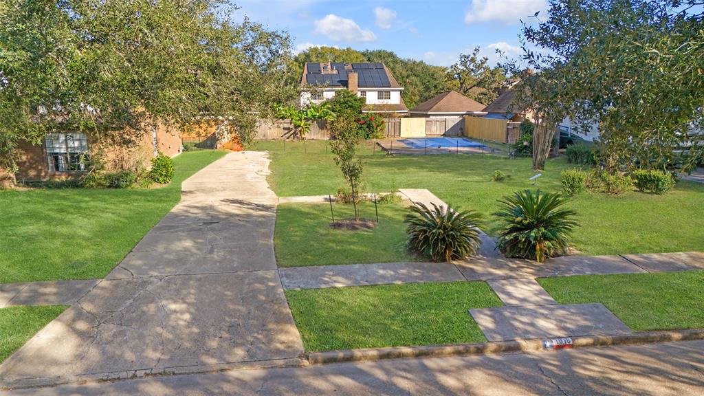 a view of a garden with a building in the background