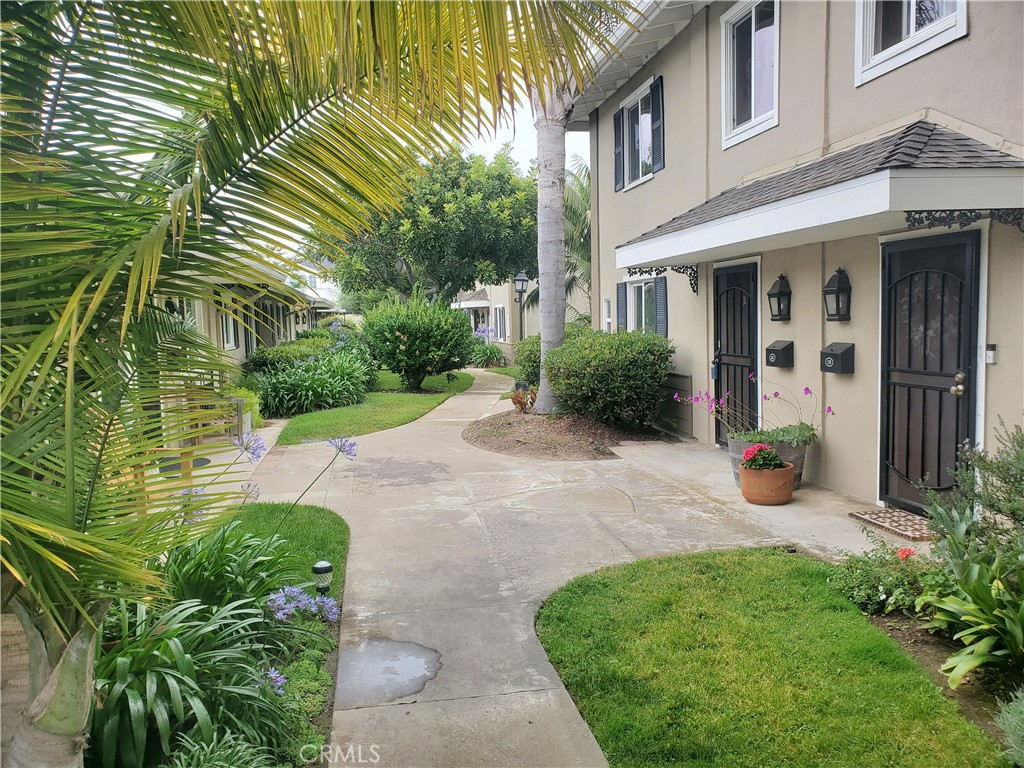 a view of a house with a yard and plants