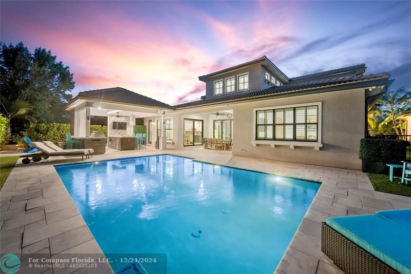 a view of a house with pool and chairs