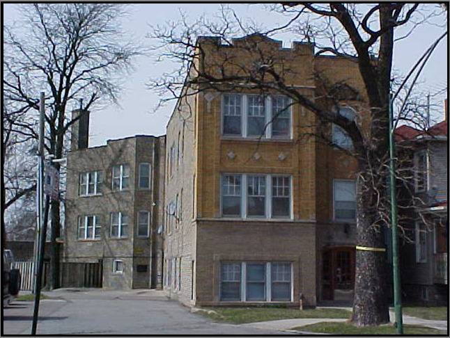 a front view of a building with a garden