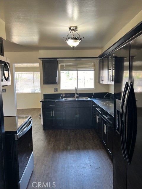 a kitchen with stainless steel appliances granite countertop a sink and a stove