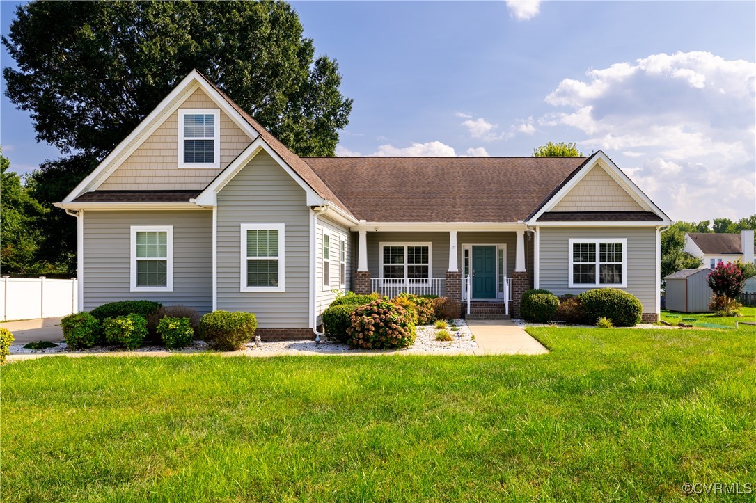 Craftsman-style home with a storage shed and a fro