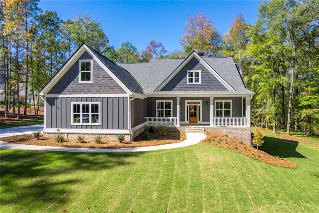 a front view of house with yard and green space