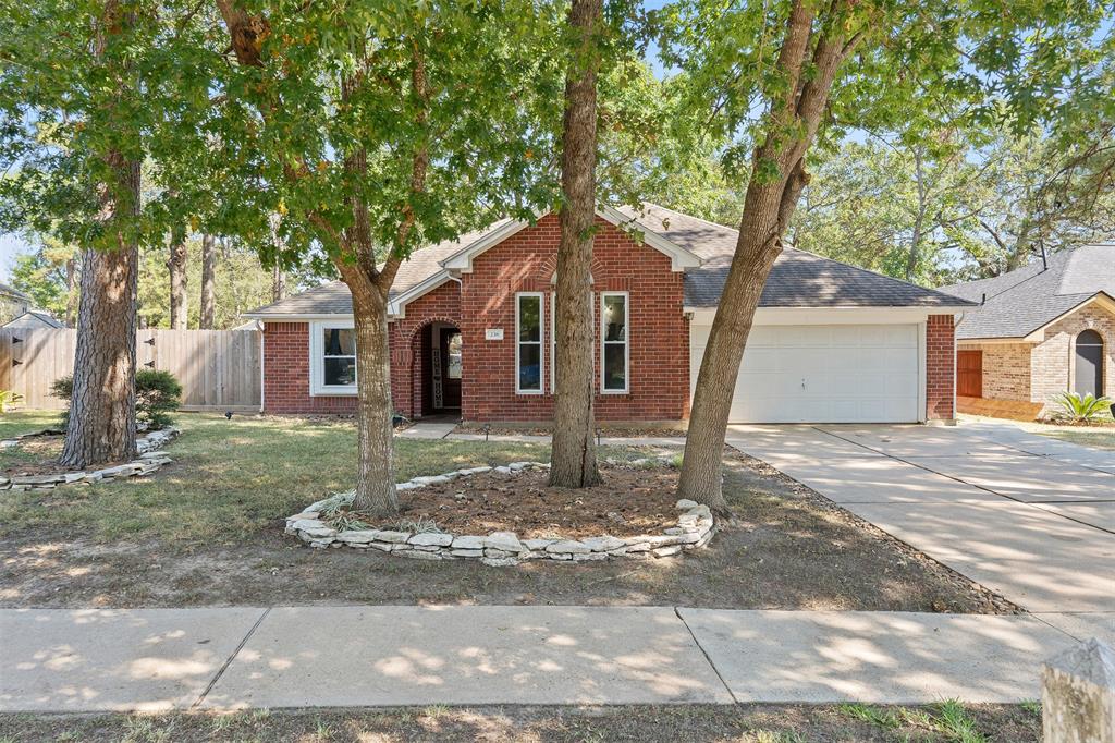 a front view of a house with a tree