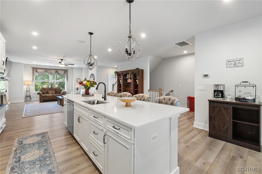 a large kitchen with kitchen island a stove a sink a center island and couches