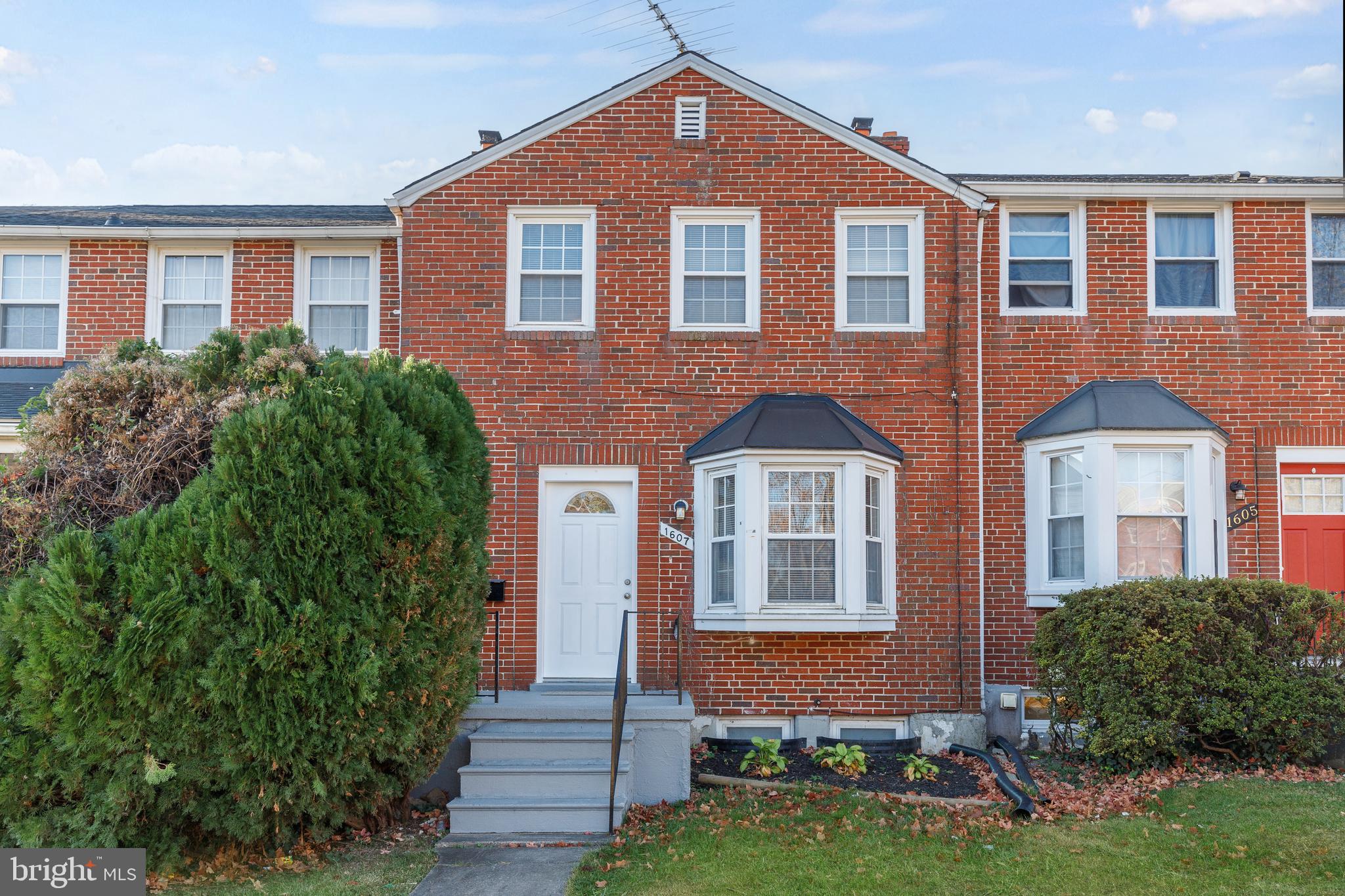 front view of brick house with a yard