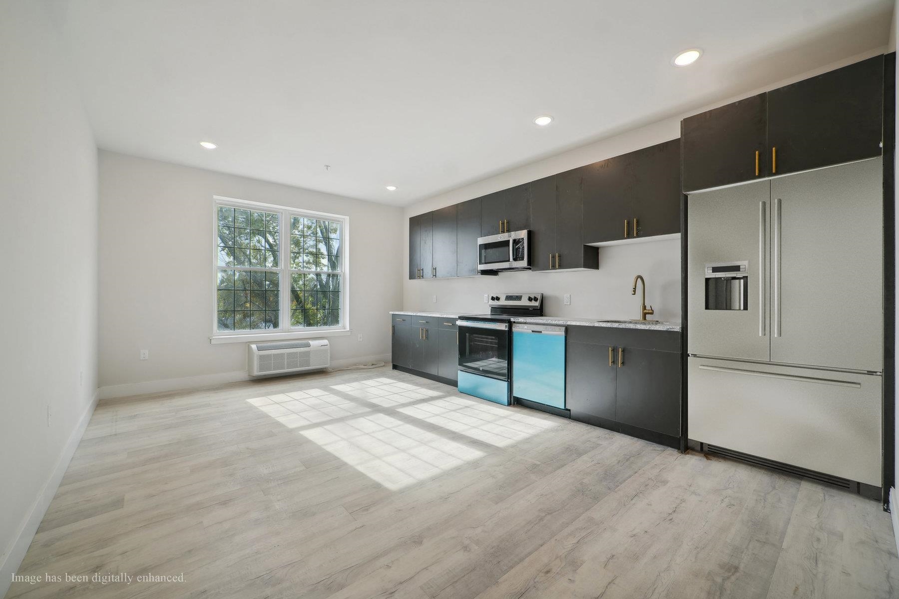 a kitchen with stainless steel appliances a refrigerator sink and cabinets