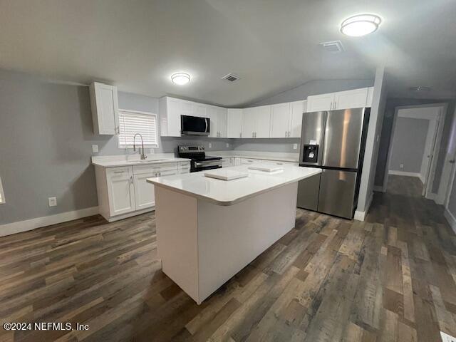 a kitchen with a stove a refrigerator and a sink