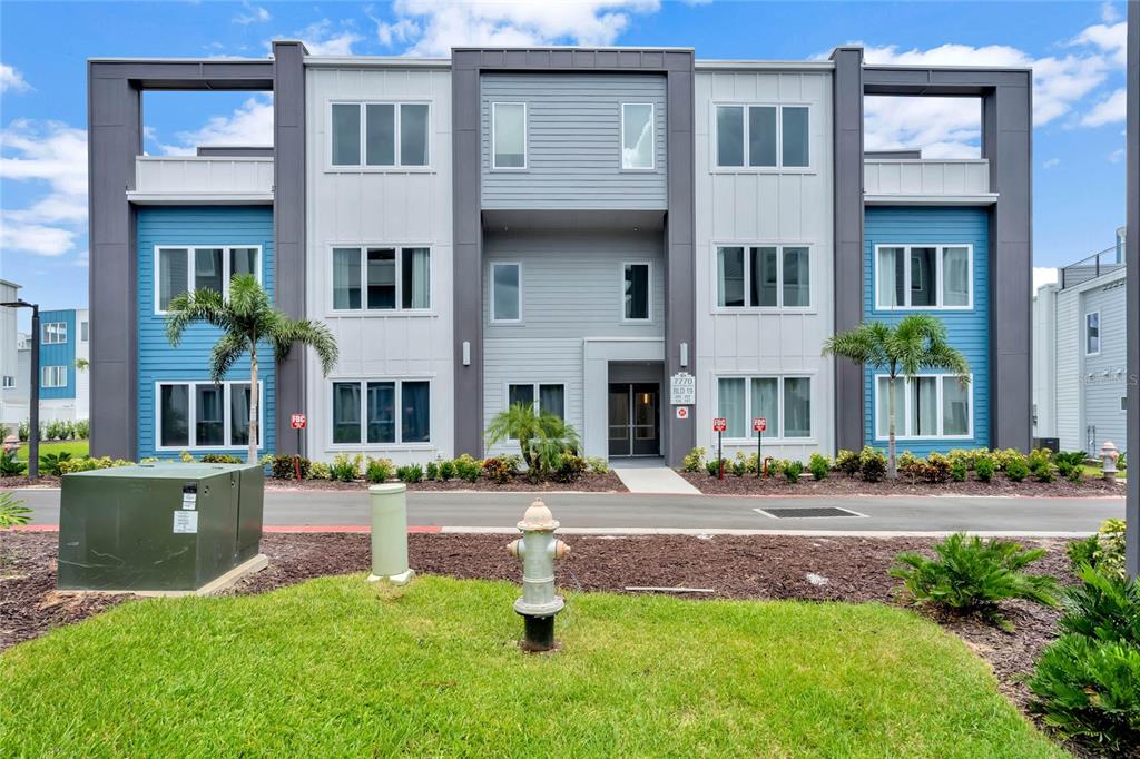 a front view of building with yard and green space