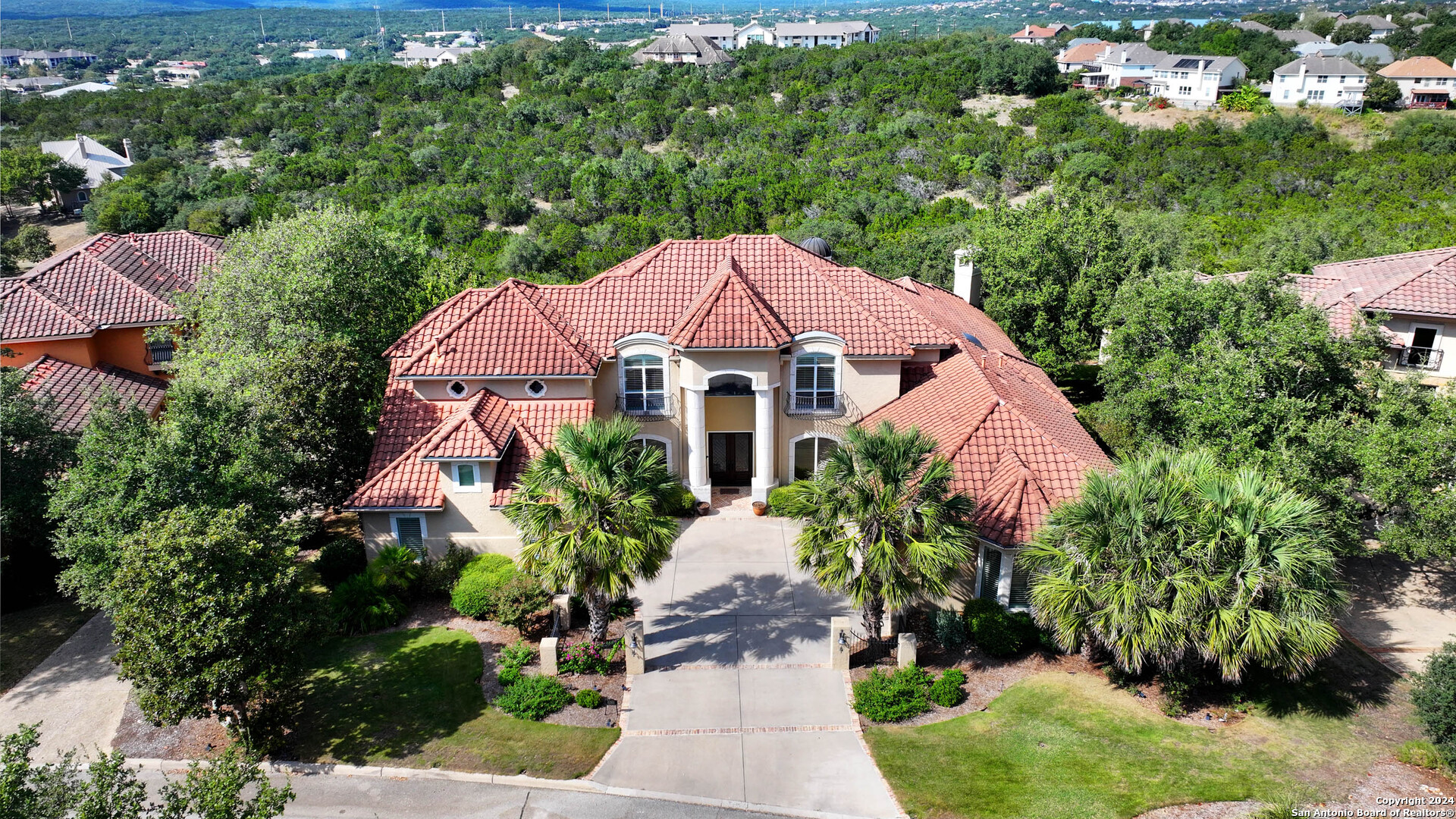 a front view of a house with a yard and garden