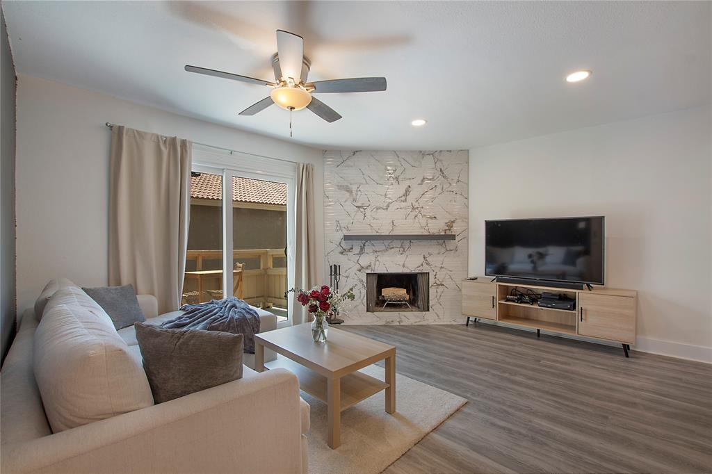 a living room with furniture flat screen tv and a fireplace