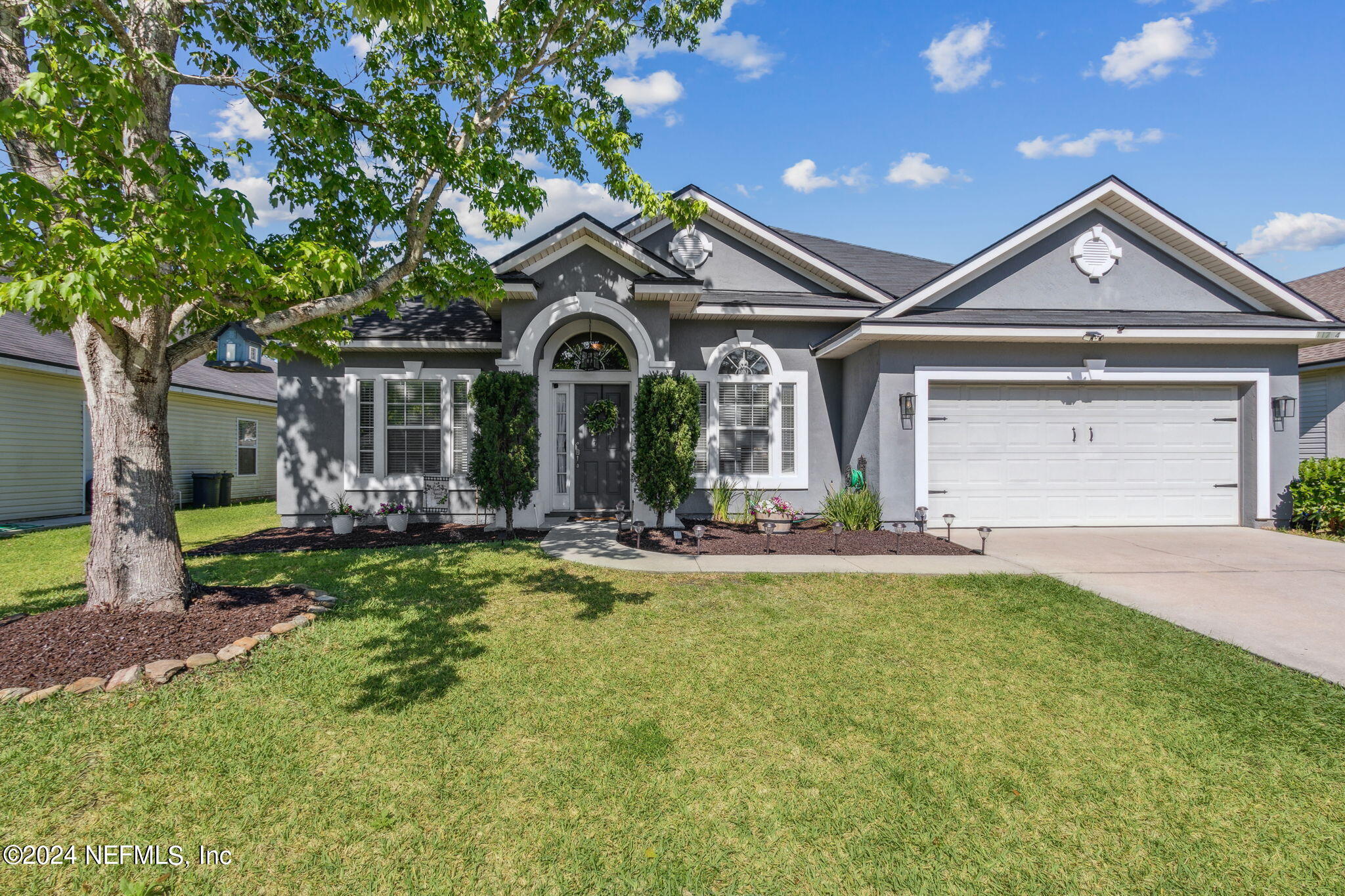 a front view of a house with a yard