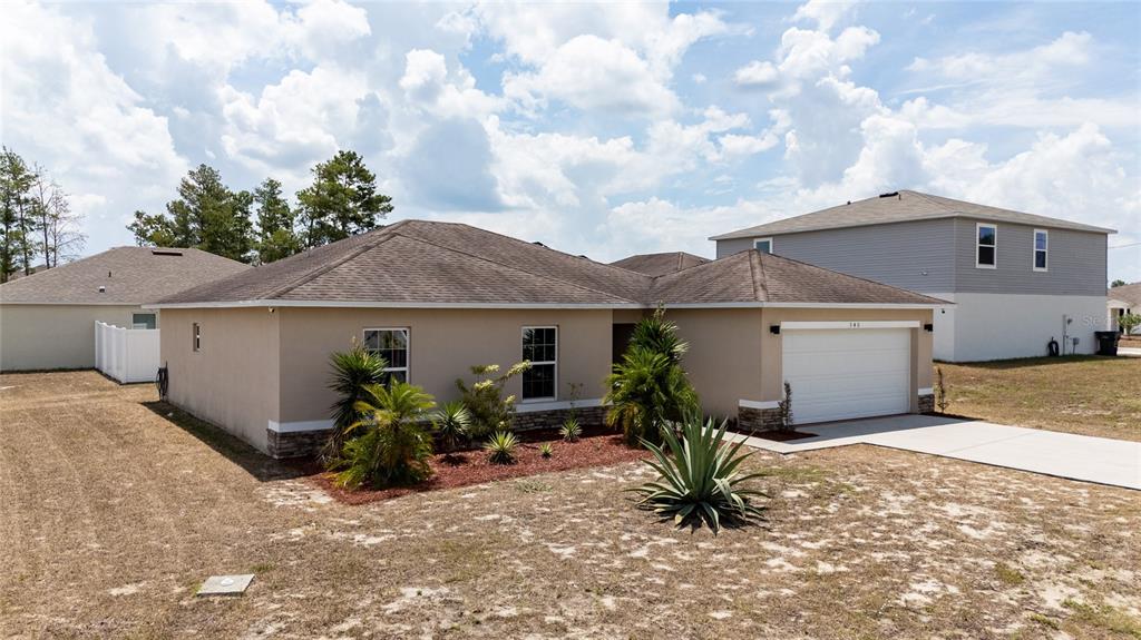 a view of house with yard and entertaining space