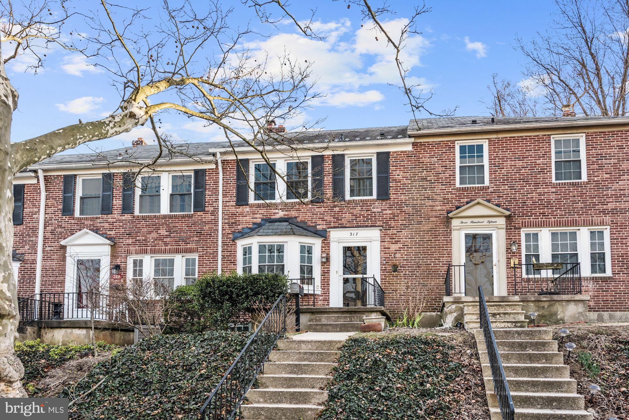 front view of a brick house with a large windows