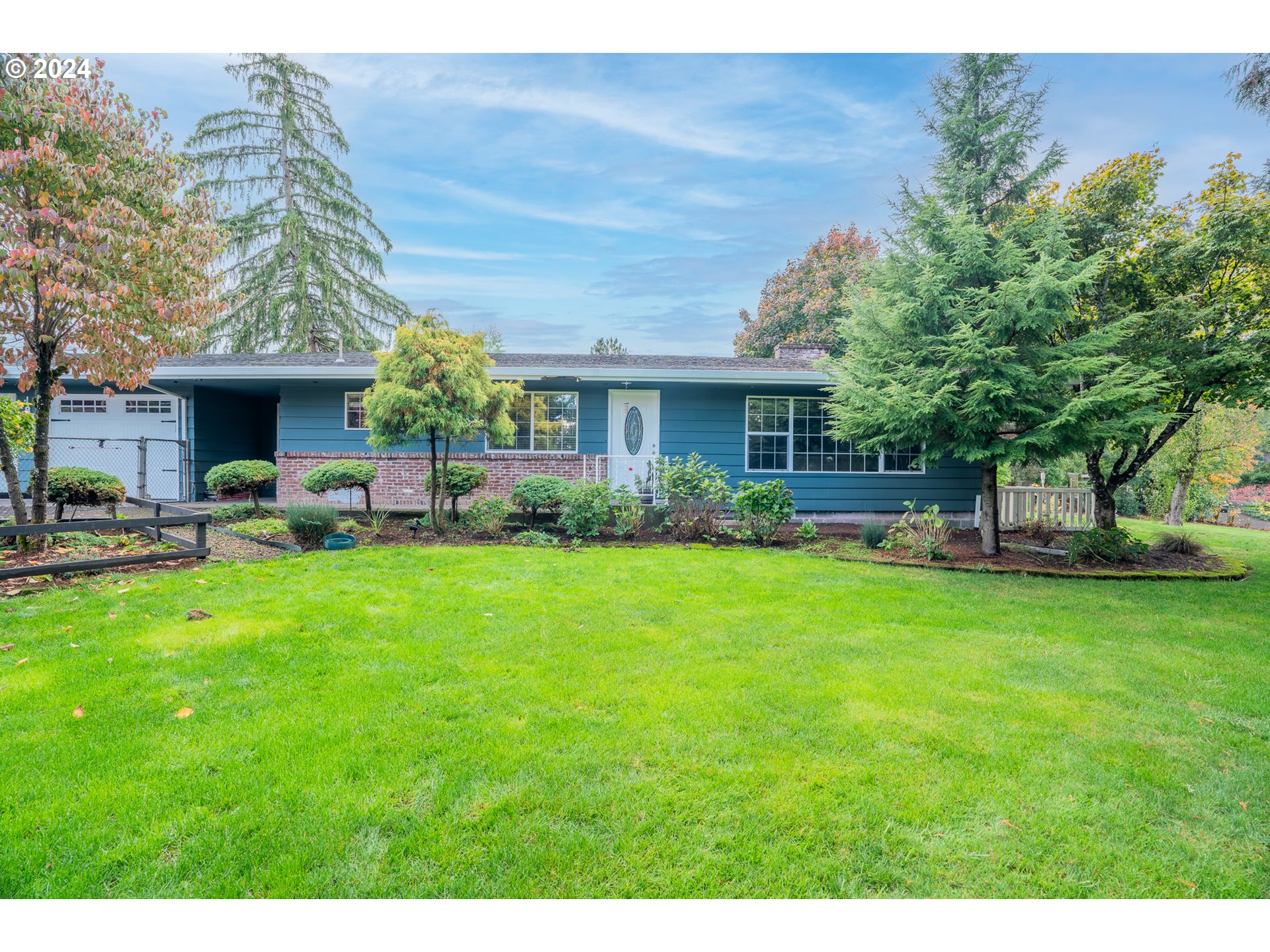 a front view of house with yard and outdoor seating