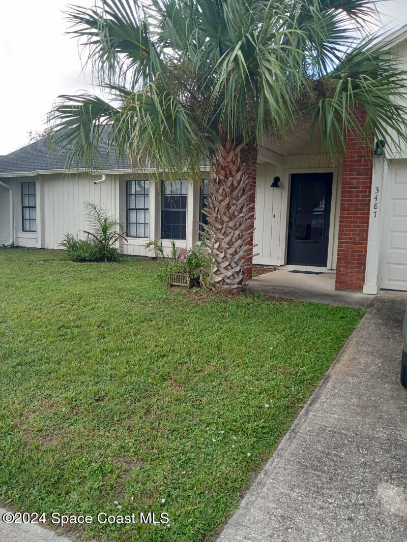 a front view of a house with a garden and yard