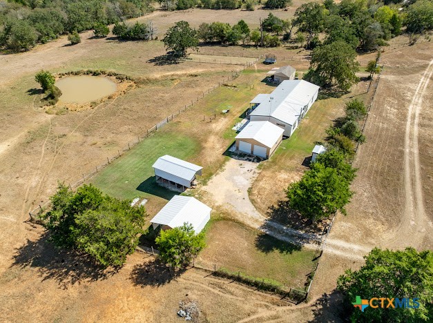 an aerial view of a house with a yard and lake view